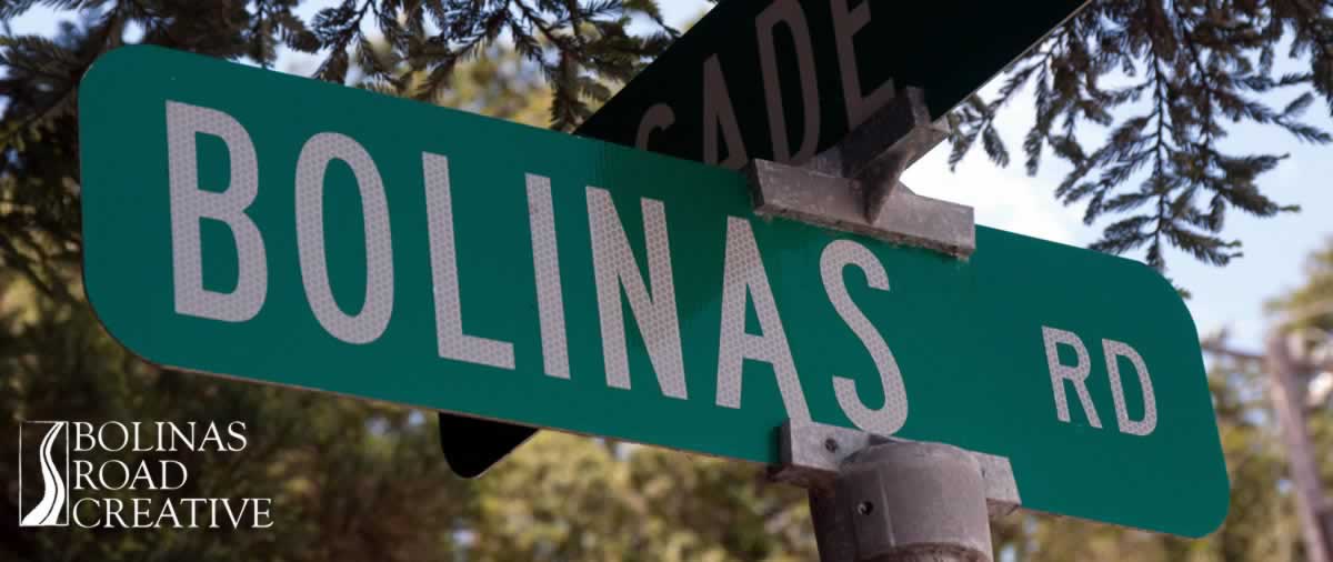 Bolinas Road street sign with redwood trees behind.